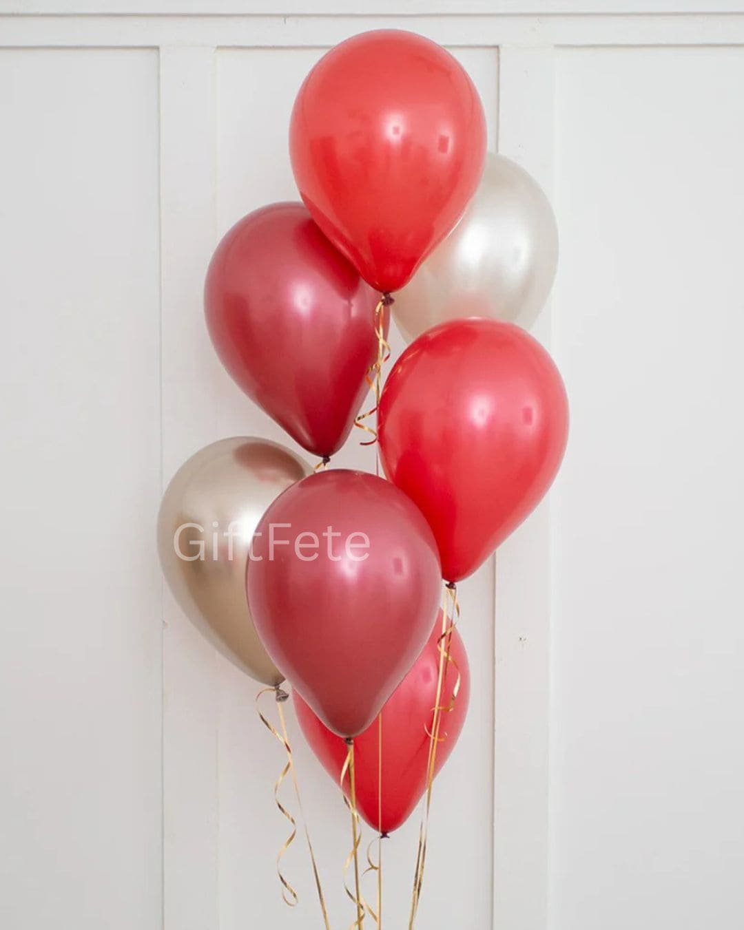 Red and gold balloons against a white background with 'GiftFete' branding.