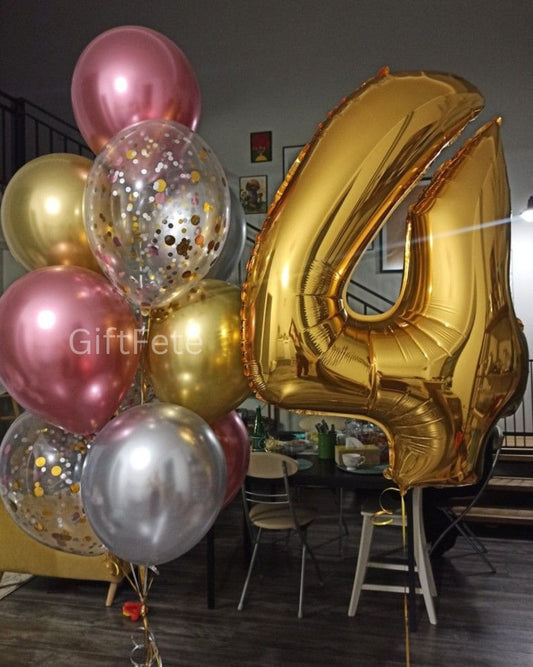 Gold number 4 balloon among other balloons in a room setting