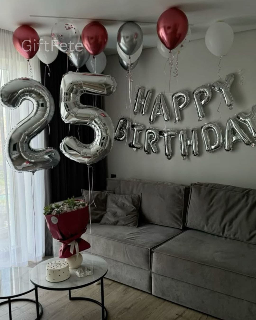 Decorative balloons spelling '25 Happy Birthday' in a living room setting.
