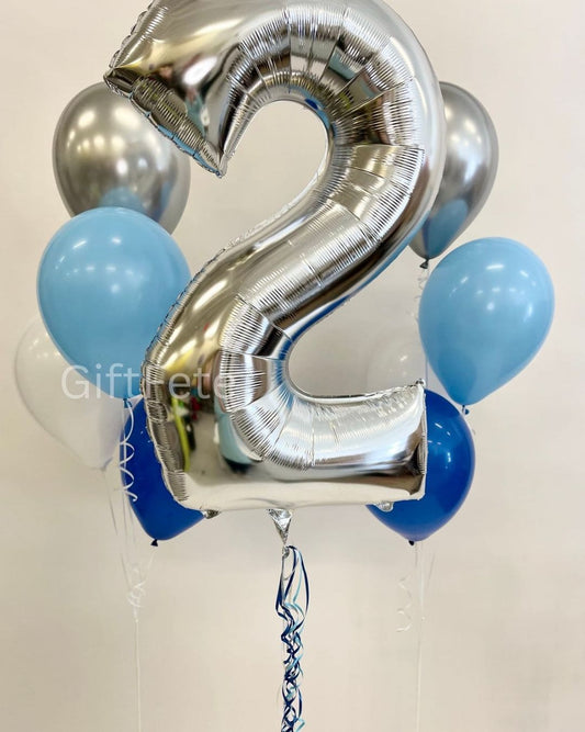 Silver number 2 balloon with blue and silver balloons on a white background