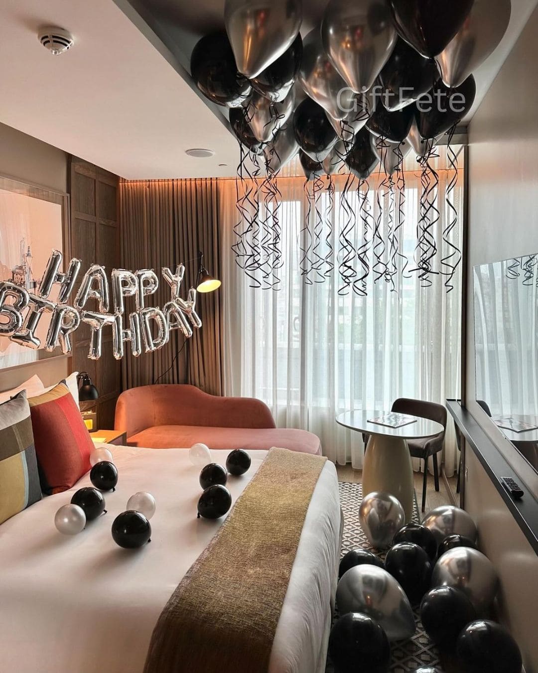 Decorated room with balloons and 'Happy Birthday' sign, featuring GiftFete branding.